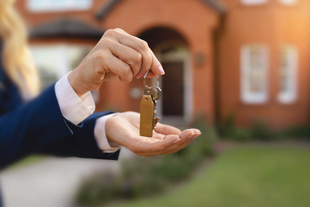 Estate agent handing over the keys to a new home